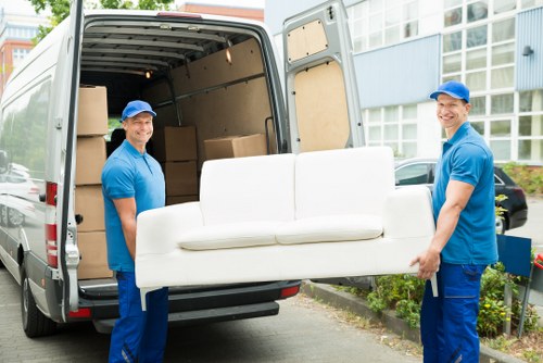 Man with a van loading furniture in Battersea street setting