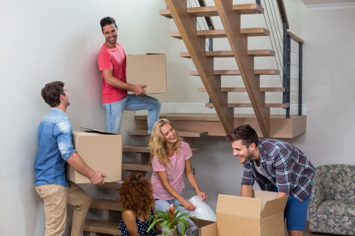 Removal team handling boxes and furniture during a Battersea home move